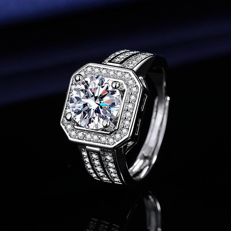 Women's silver signet-style ring with a large round-cut center stone and pave-set crystals along the band on a dark background.